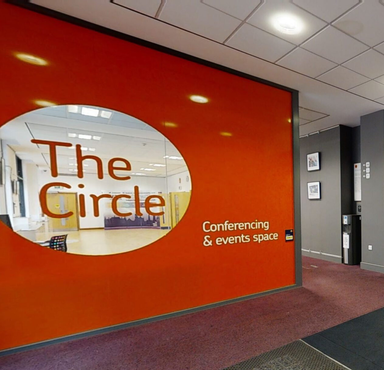 Exterior view of the Circle Conference Centre, highlighting its unique circular architecture and inviting entrance area.