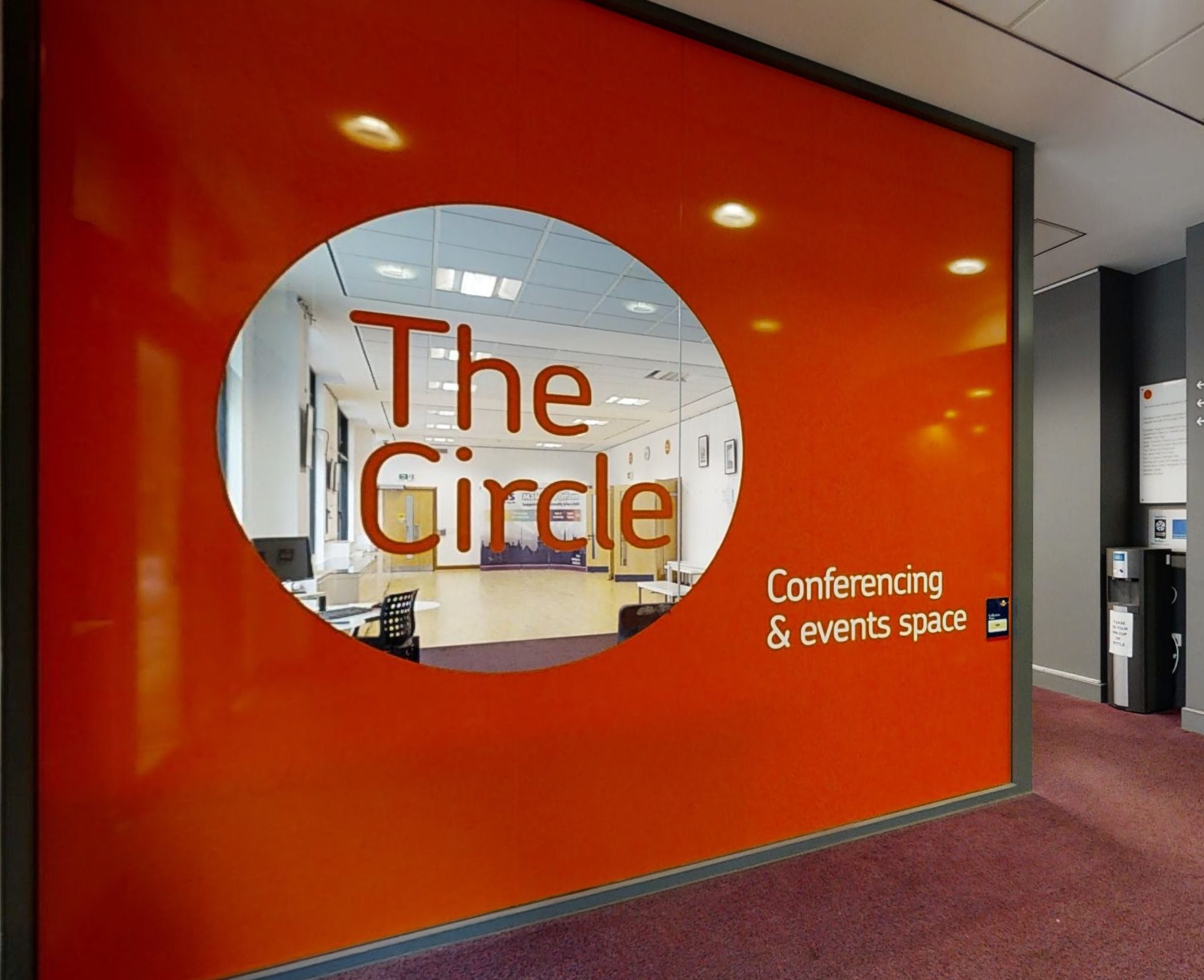 Exterior view of the Circle Conference Centre, highlighting its unique circular architecture and inviting entrance area.